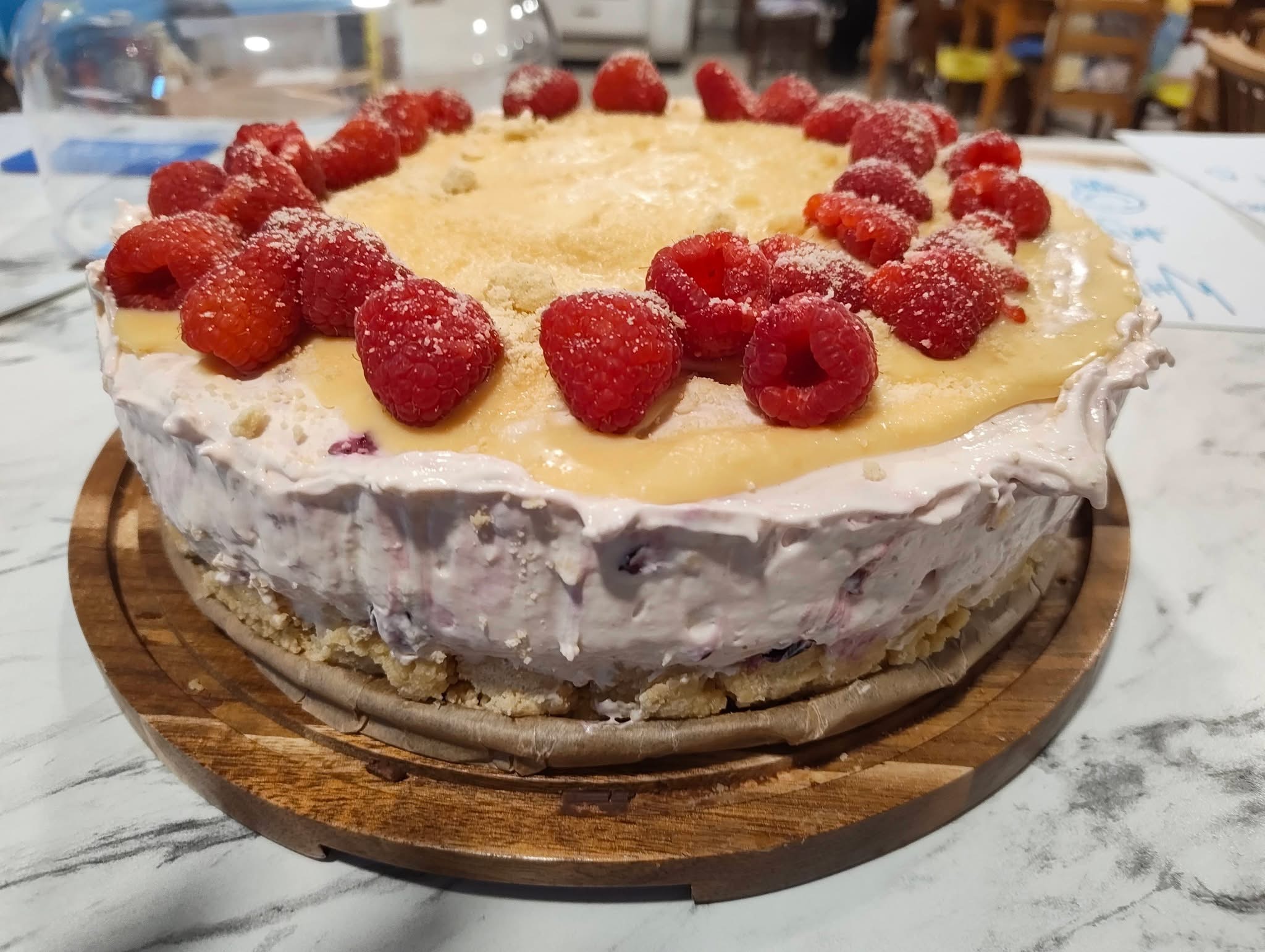 Raspberry cheesecake on wooden board