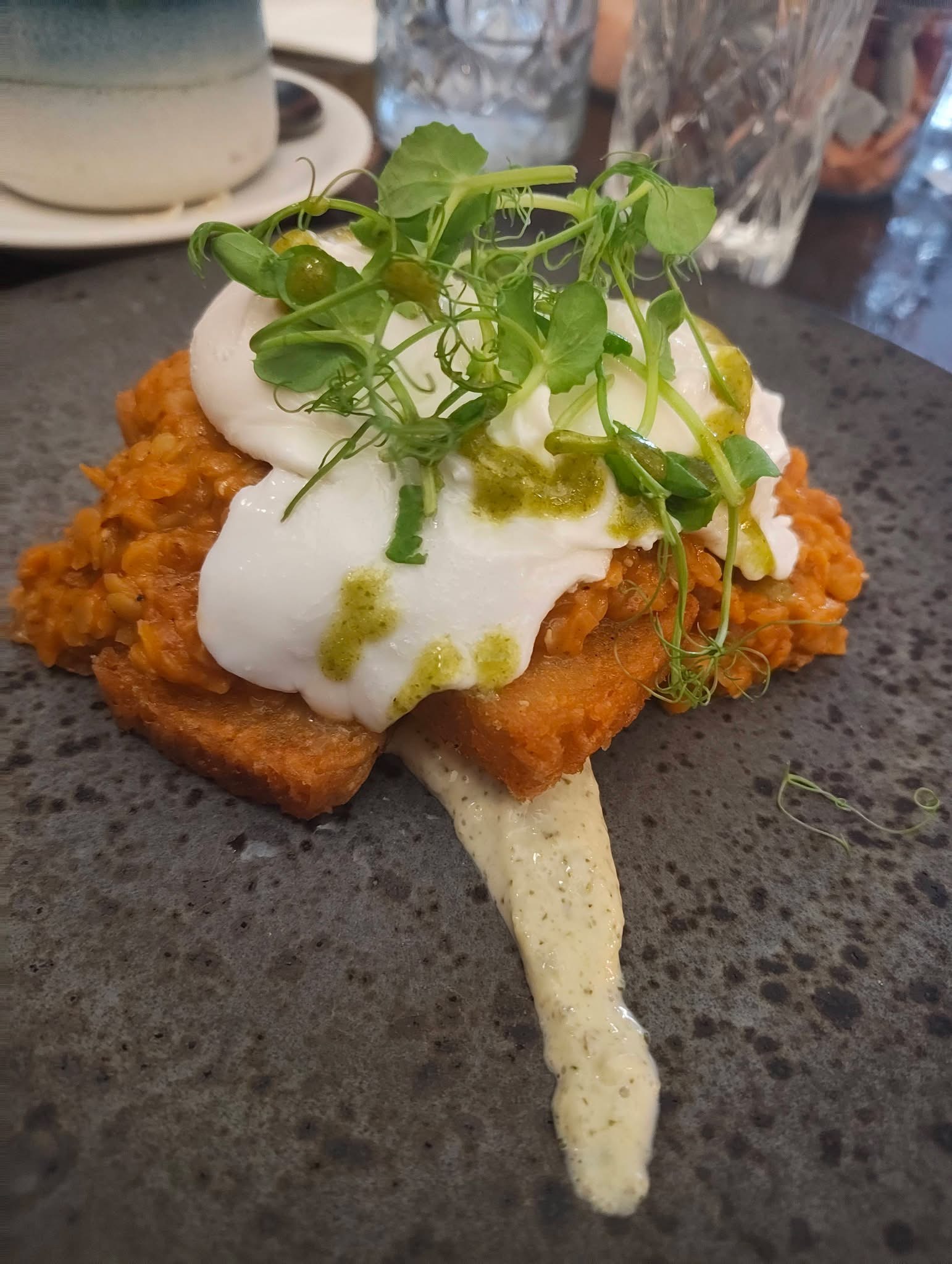 Poached egg brunch with hash brown and pea shoots