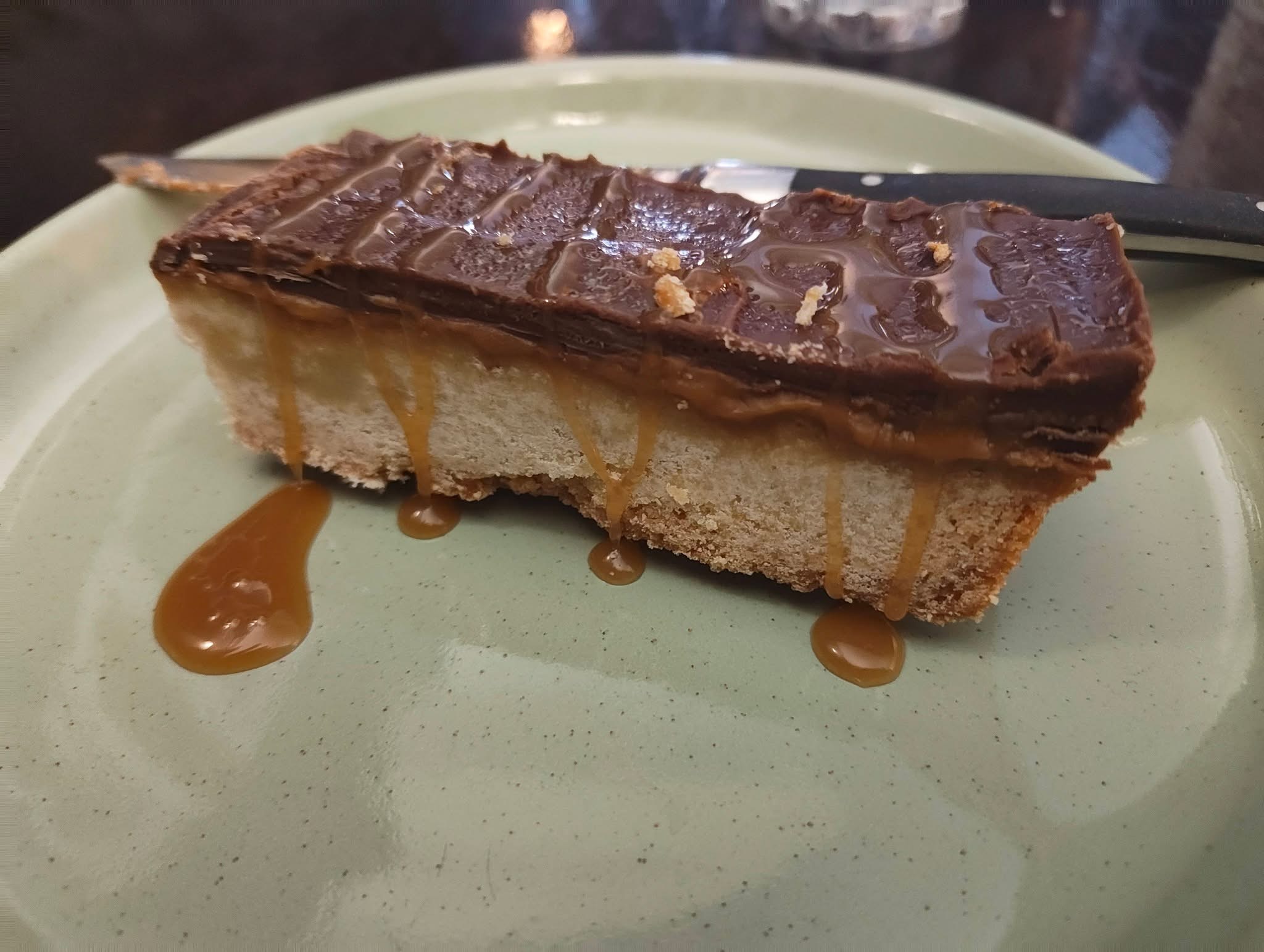 Chocolate caramel cheesecake with dripping caramel